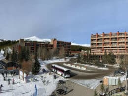 Front of Beaver Run Resort and Conference Center with a ski lift right next to the driveway