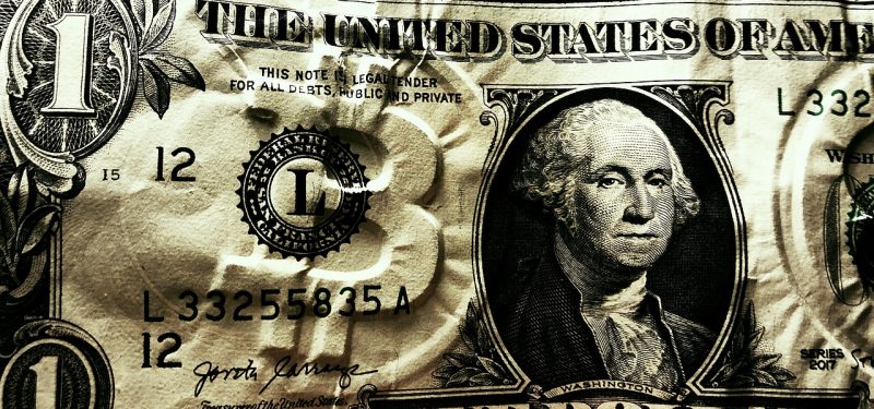 Dollar bill with embossed Bitcoin logo