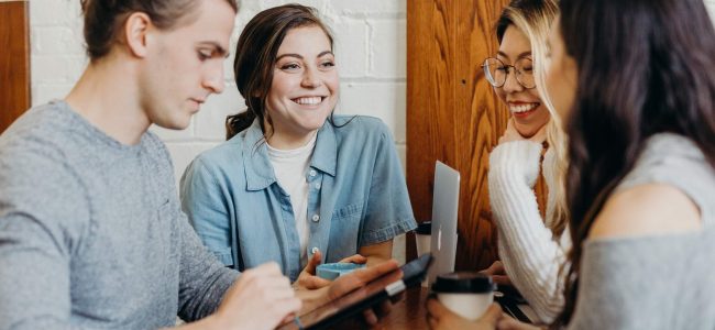 Group of students, studying, over coffee with technology