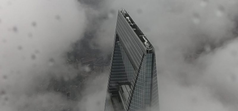 Ariel photograph of high rise building pushing through clouds