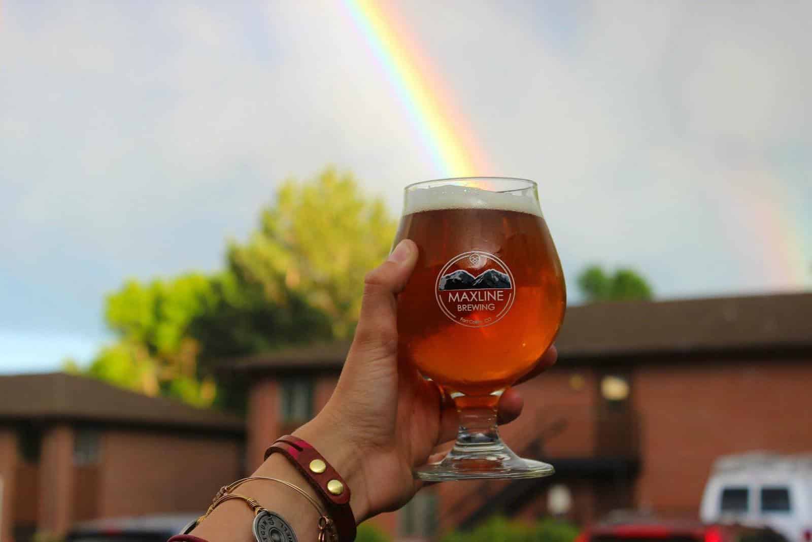Image of a drink from Maxline Brewing with a rainbow going into it in Fort Collins, Colorado