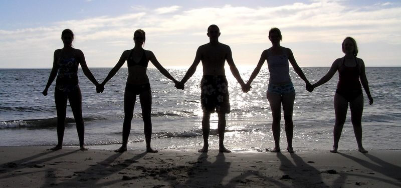 People holding hands on a beach