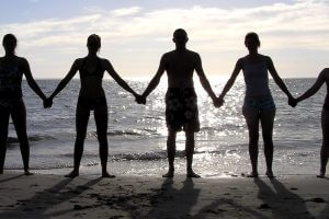 People holding hands on a beach