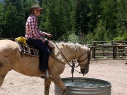 Image of a woman riding a horse at Tumbling River Ranch in Grant, Colorado