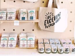 Wooden peg board with canvas totes, candles, and pins